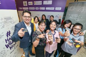 Man and women holding micro:bit boards