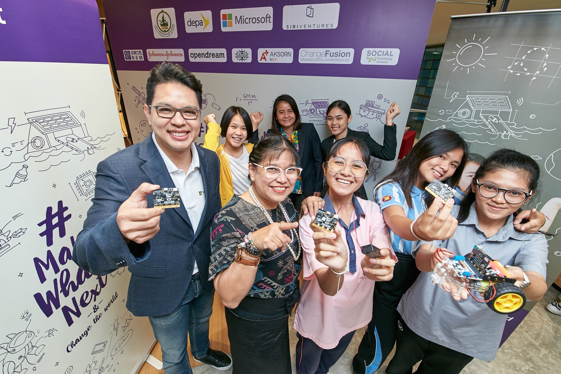 Man and women holding micro:bit boards