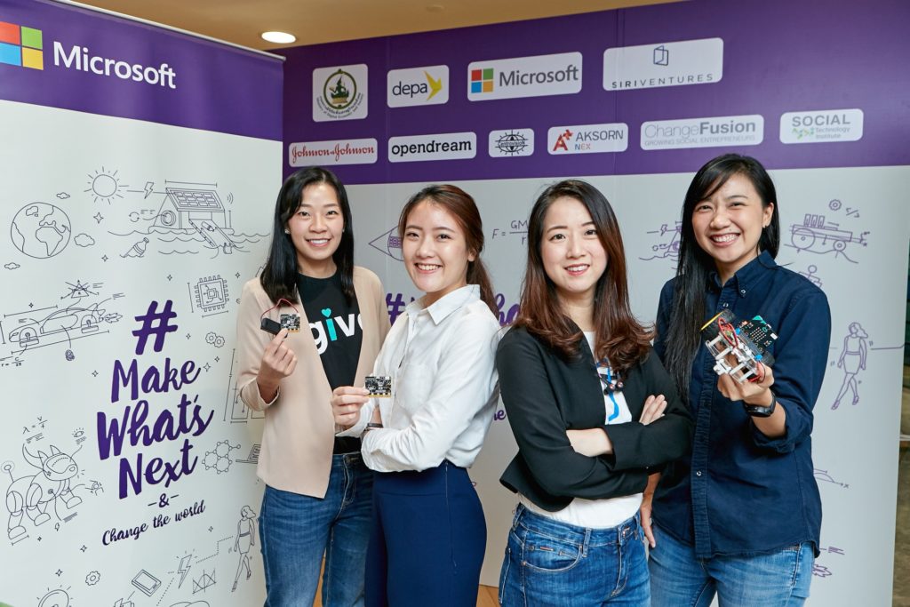Four women in front of backdrop