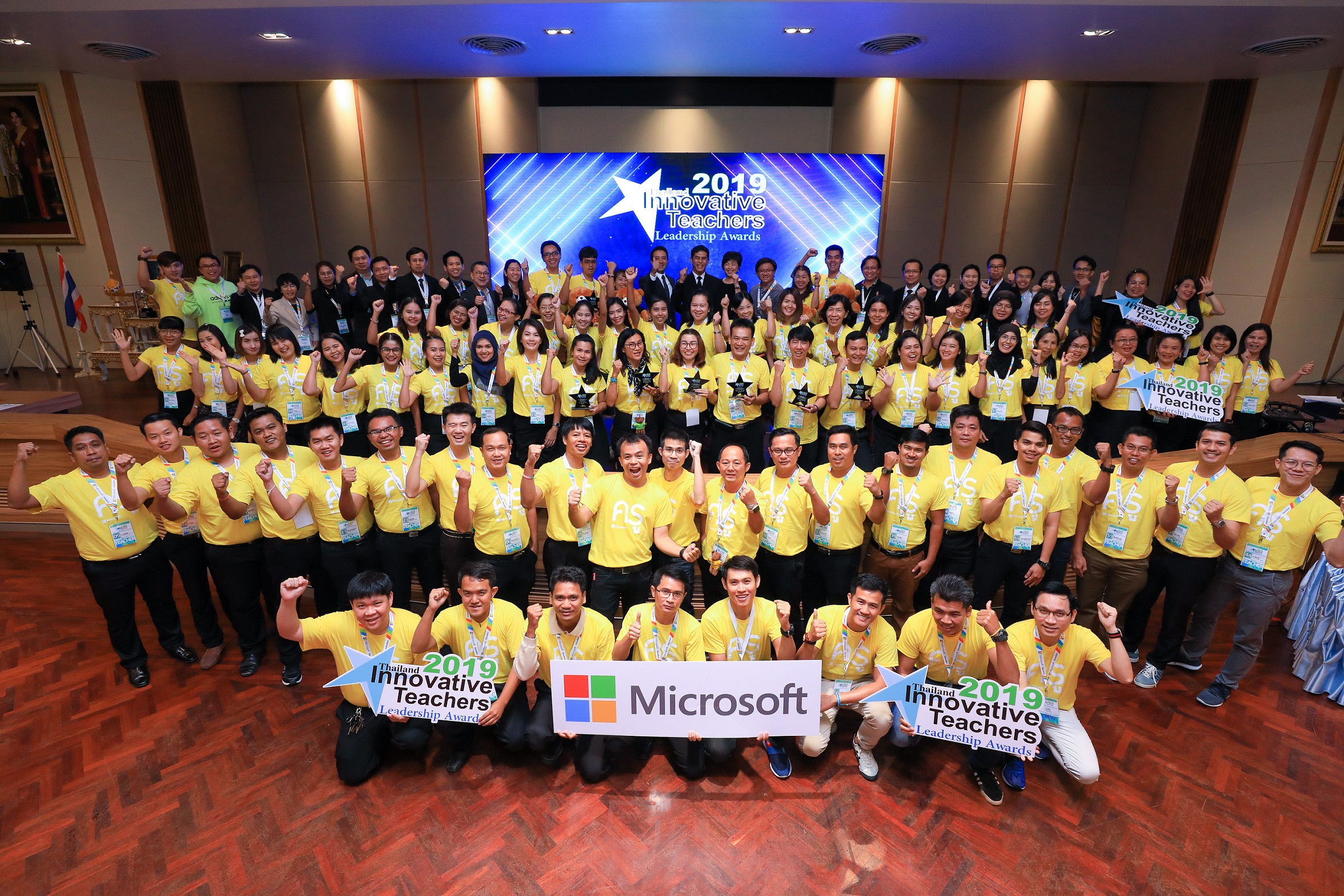 Group of people in yellow shirts in event