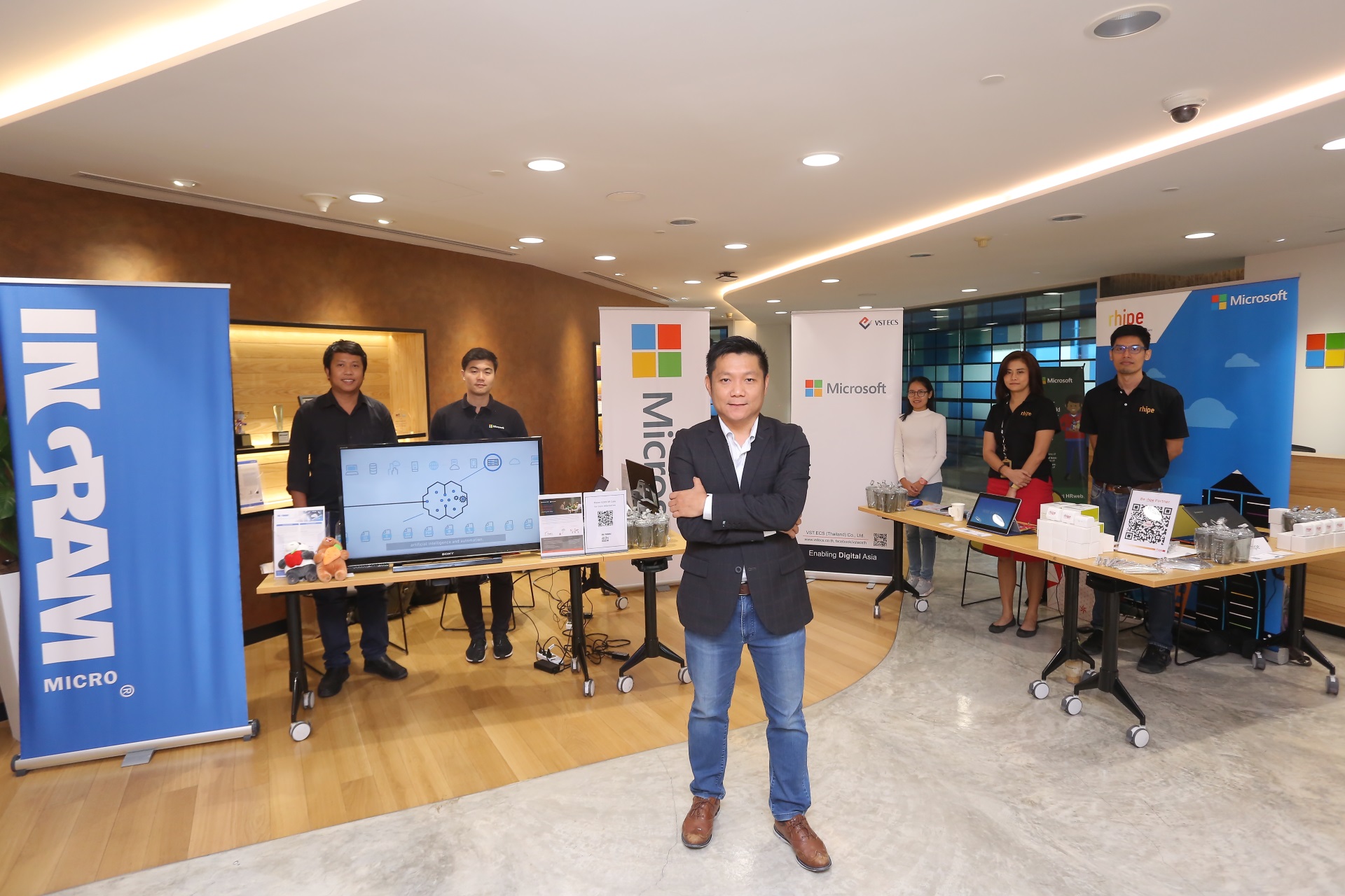Microsoft executive standing in front of Microsoft partner booths