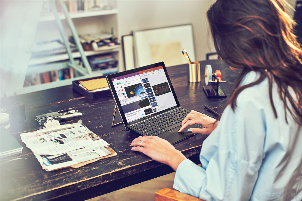 Woman shown from behind using a Surface device