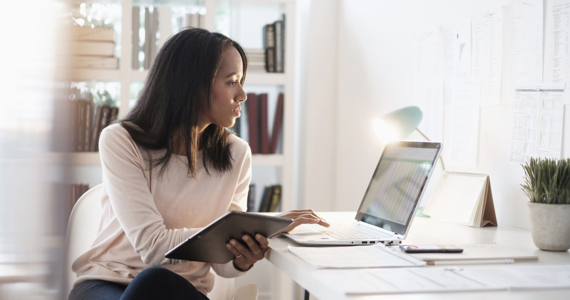 Woman using laptop and tablet