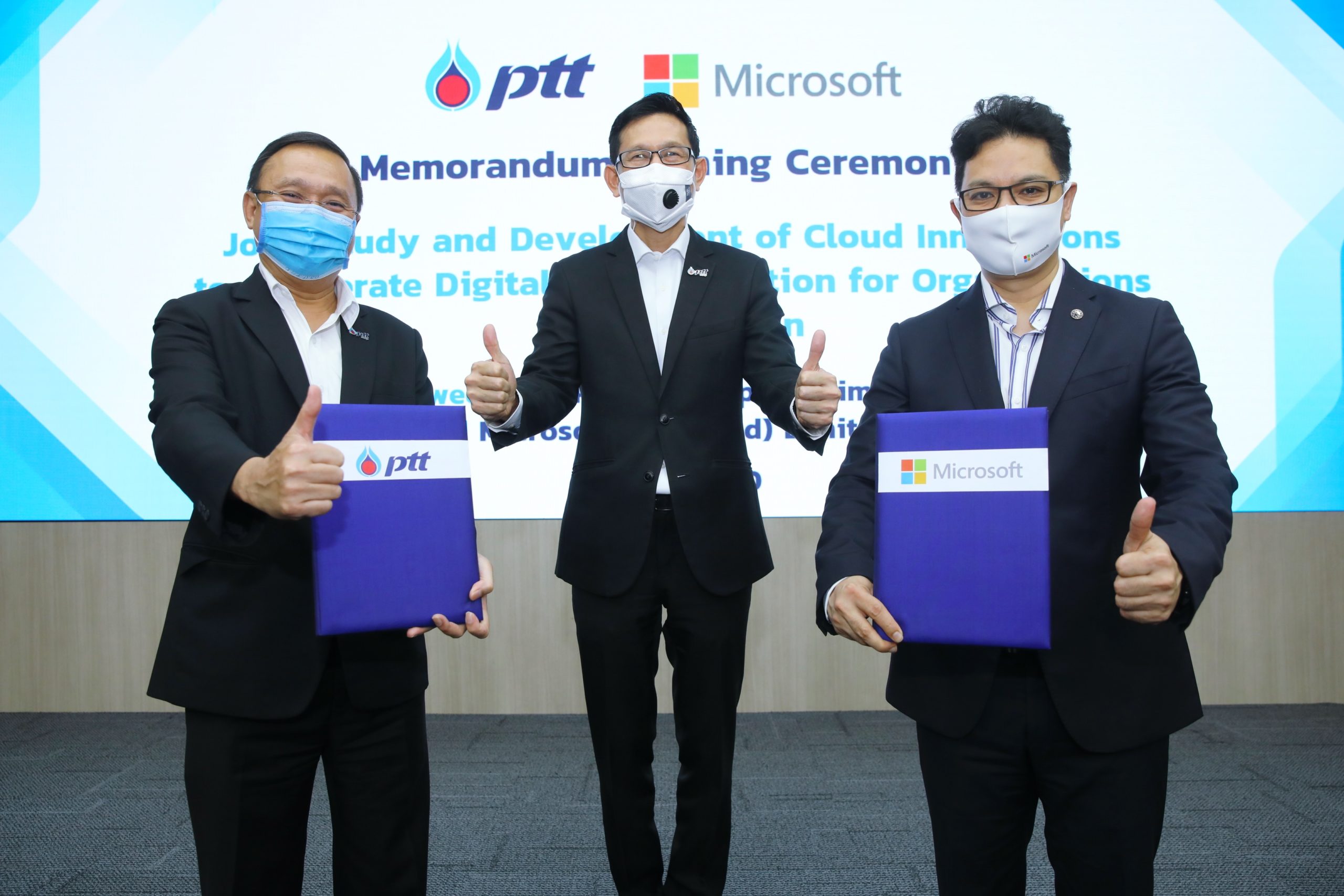 Three men in suits in MOU signing ceremony