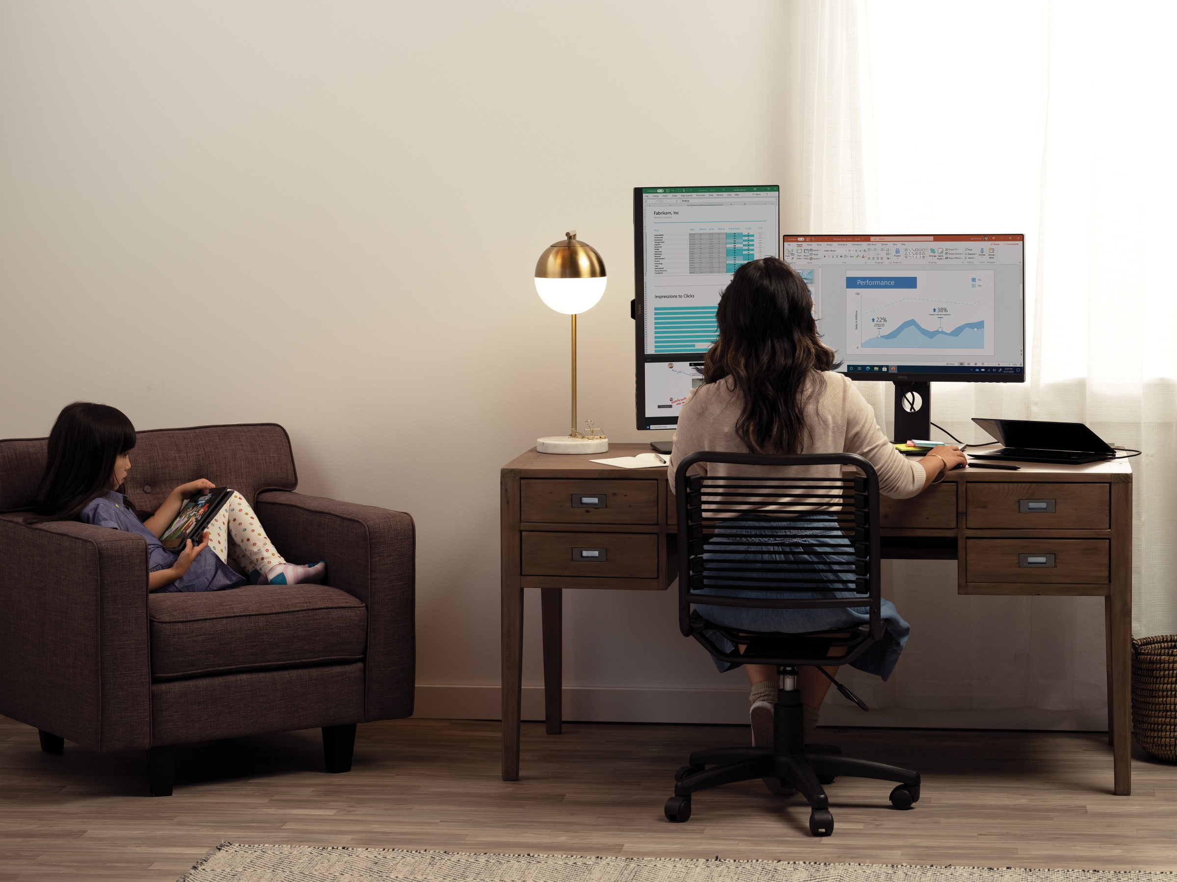 Woman working at home with child