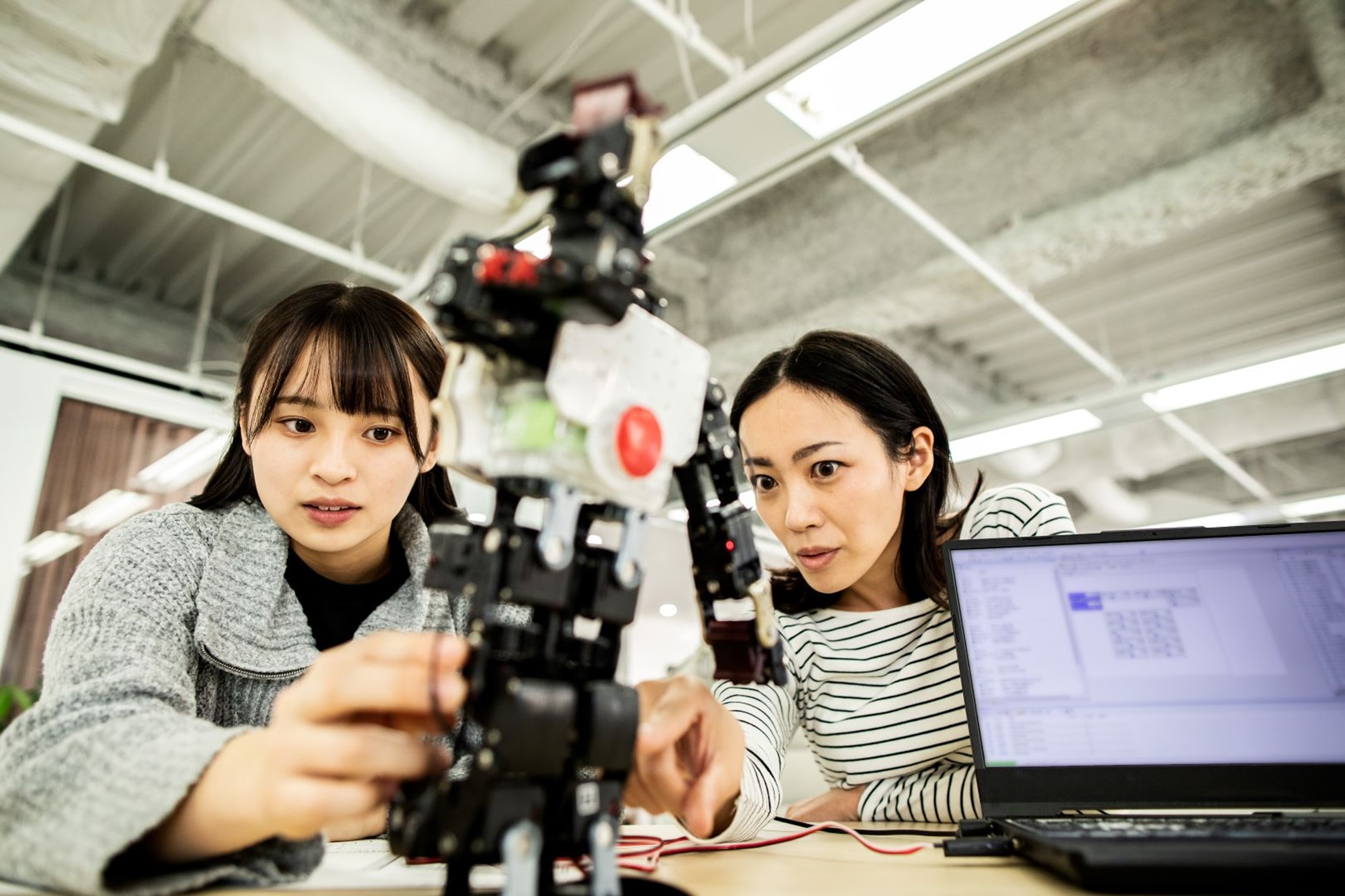 two women building robot