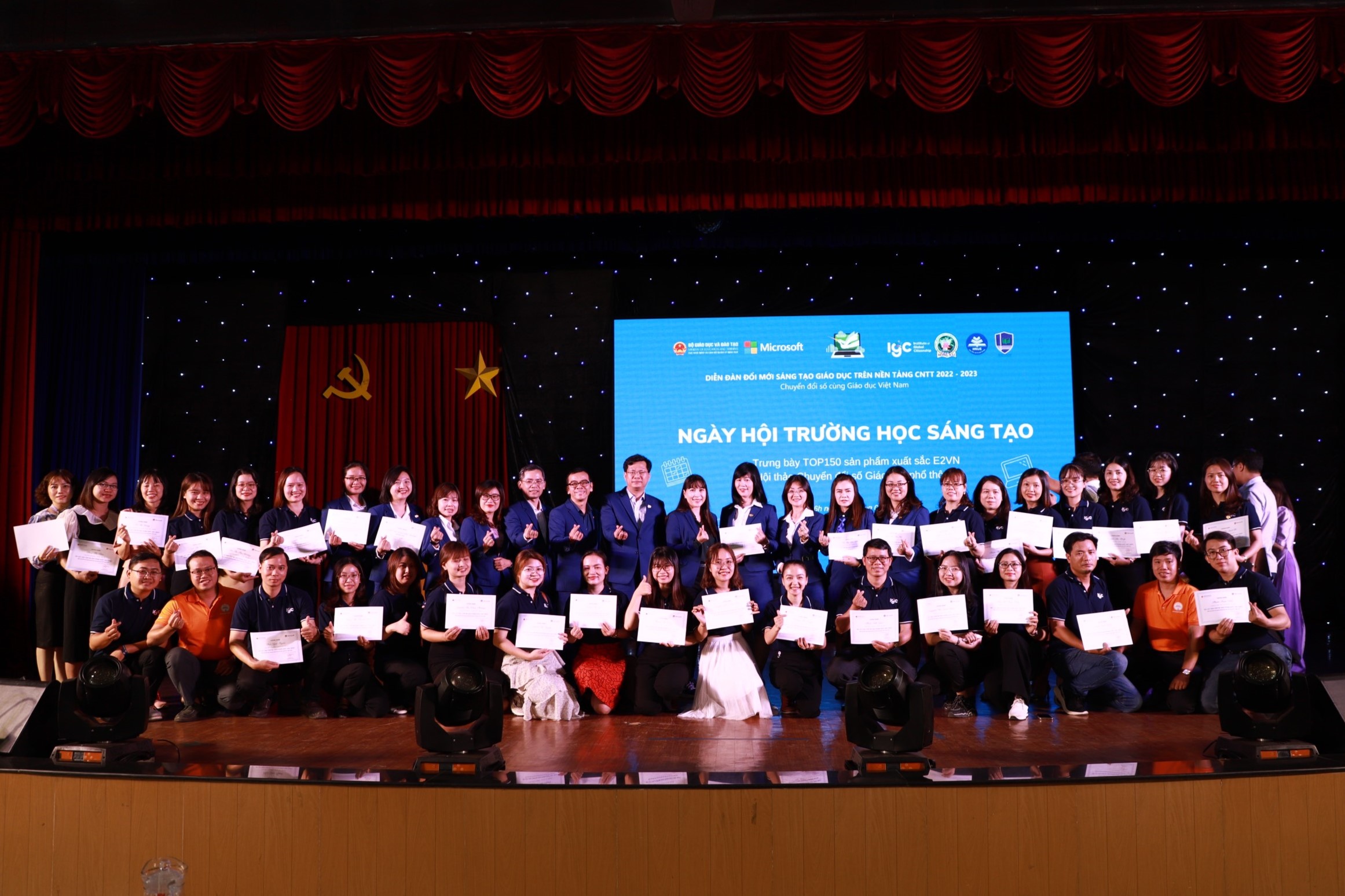 people smiling on a stage