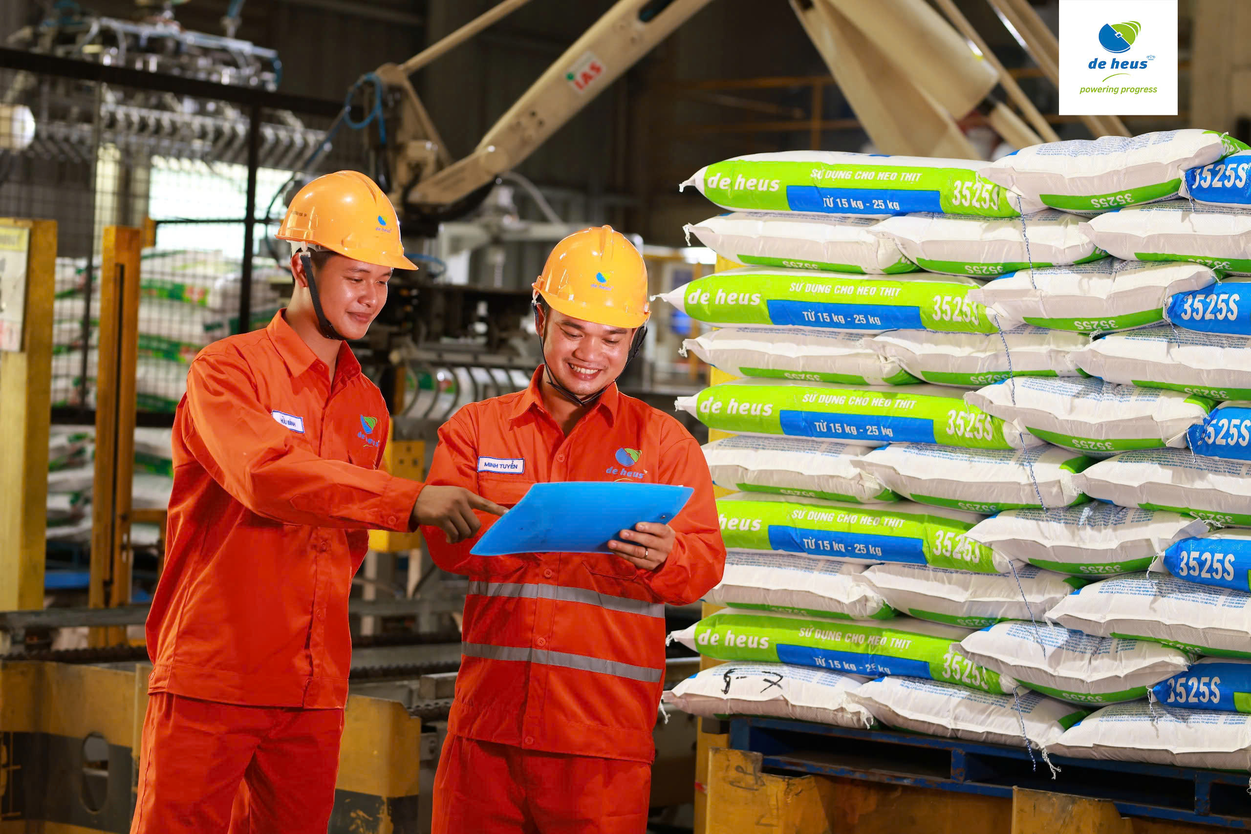 Two workers standing in the De Heus factory