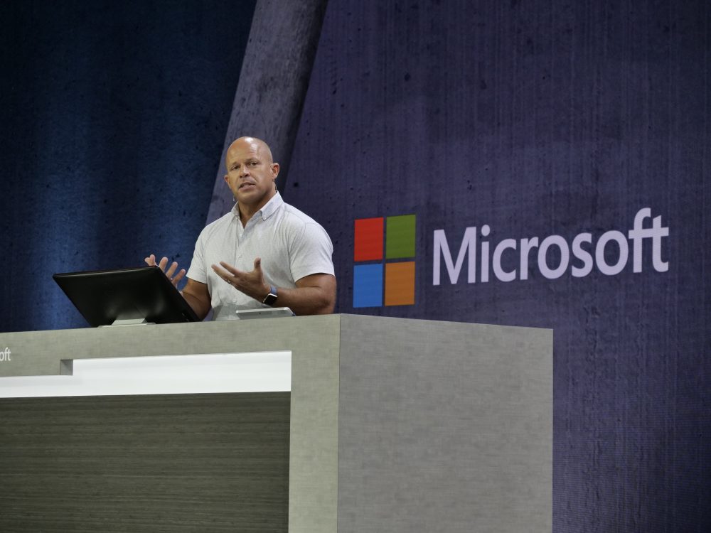 A man stands on stage at a podium delivering a speech.