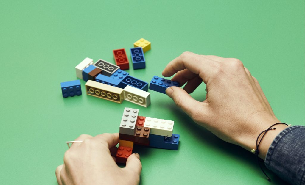 Photo of hands building lego