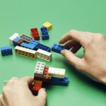 Photo of hands building lego