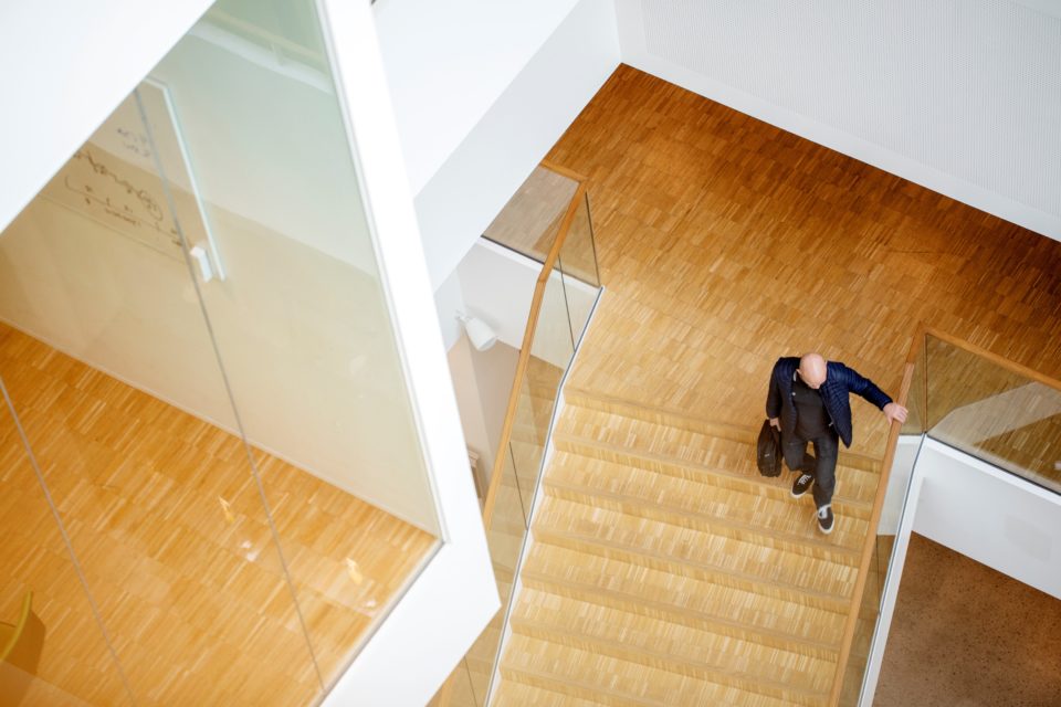 Image of man walking down stairs