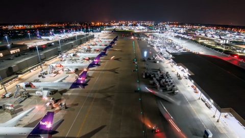 Airport showing FedEx planes lined up at the gates.