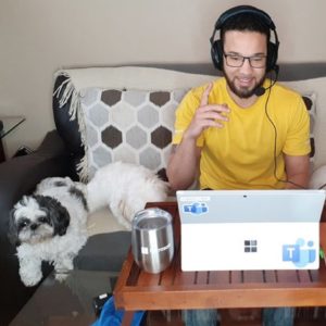 young man in front of a surface laptop