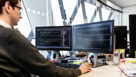Man sits on a computer in an office
