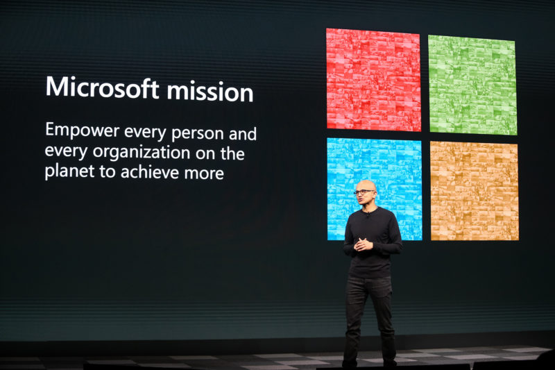 Microsoft CEO Satya Nadella stands on a stage during the MWC Barcelona event
