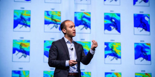 Man wearing dark suit doing a presentation
