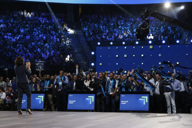 People stand in audience cheering