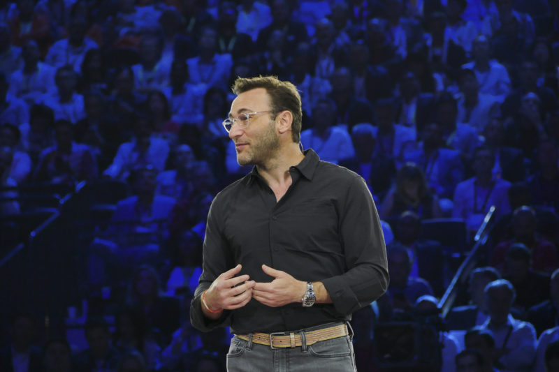 A man stands on stage presenting.