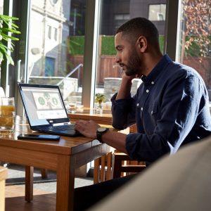 Man works on his laptop computer in a home office