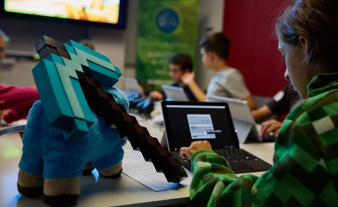 kid programing in Minecraft on Surface Go