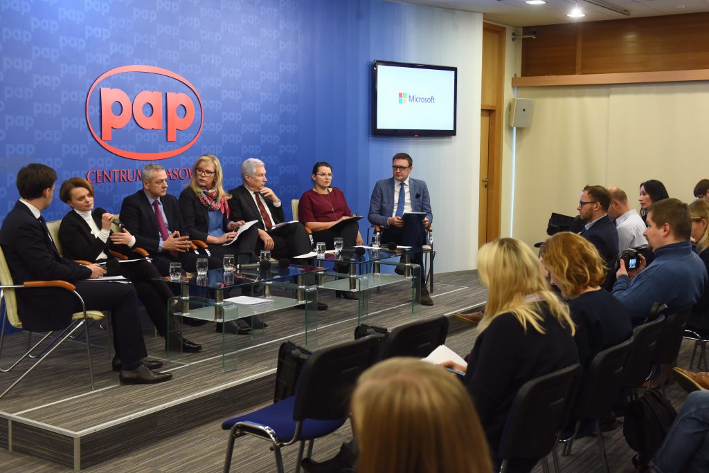 people in panel discussion observed by audience