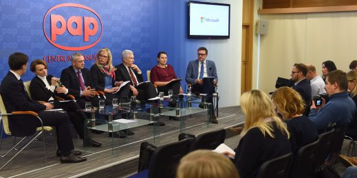 people in panel discussion observed by audience