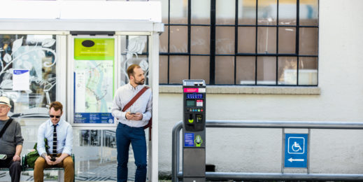 a man waiting on the bus stop