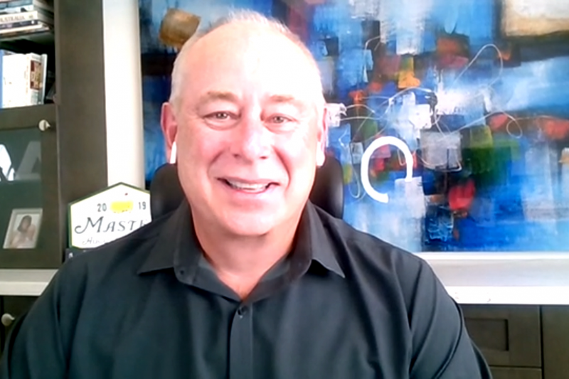 Man in black shirt smiling