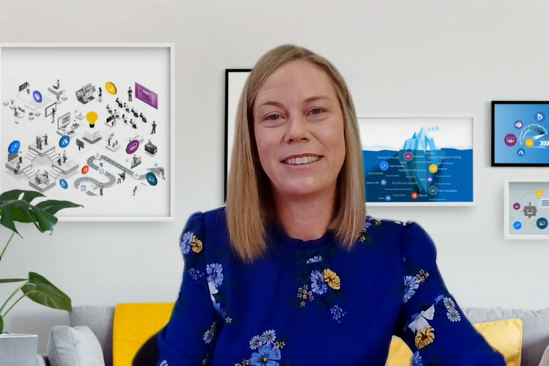 Woman in blue print shirt with artwork in background