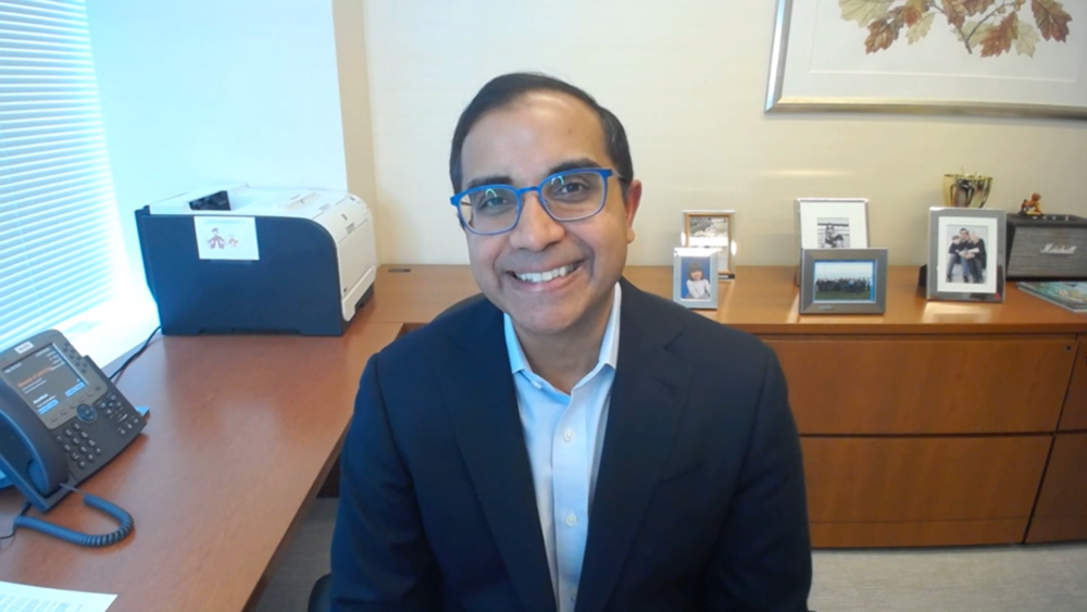 Man in suit and glasses smiling