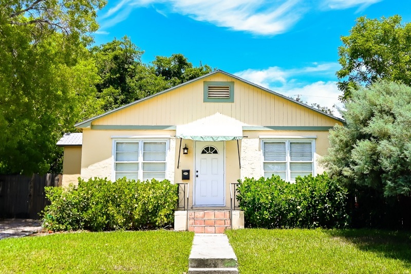 Front of a small house with a green lawn