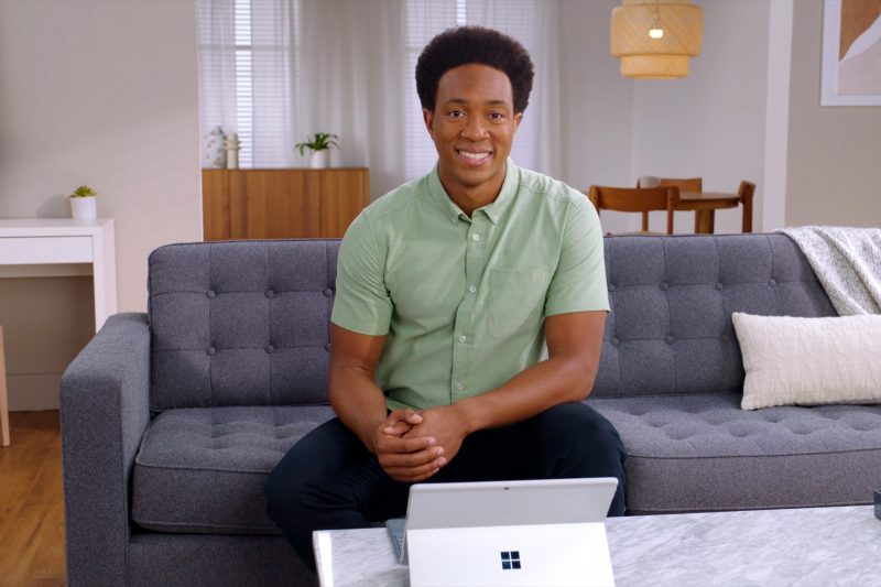 Man sits on couch in front of a tablet