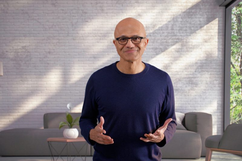 Man (Satya Nadella) stands in front of wall