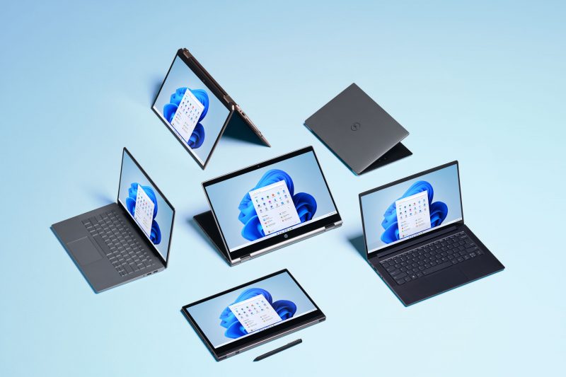 Photo of laptop and tablet devices with Windows 11 desktop rendered on screens