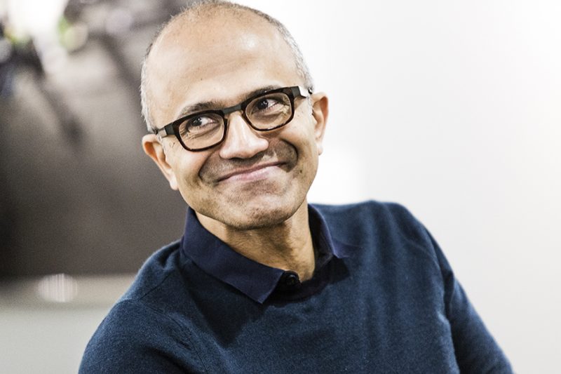 A man wearing glasses and smiling