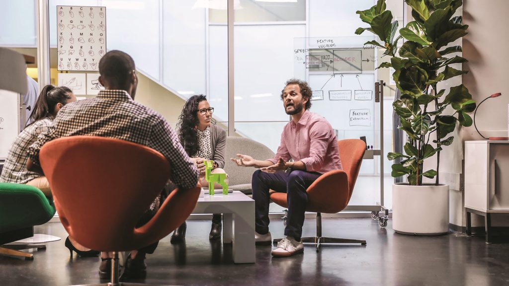 A group of people meeting in a room