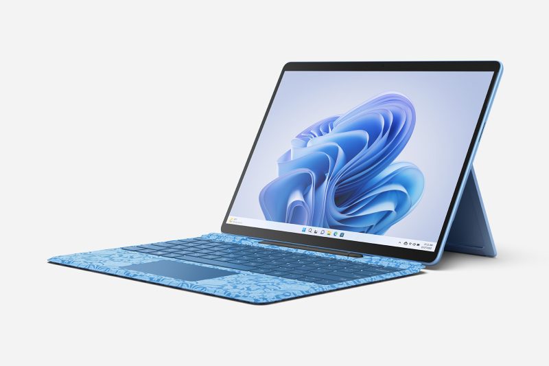 A tablet computer with kickstand is attached to a keyboard with its screen on.