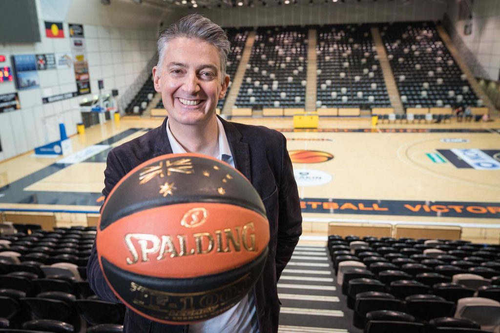 Basketball player holding basketball.