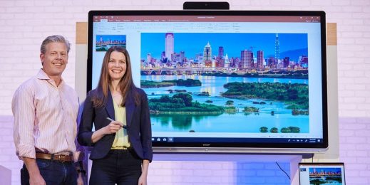 Man and Woman in front of a surface hub