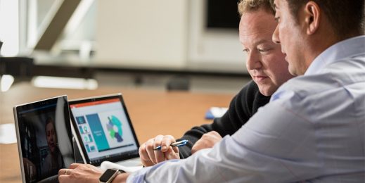 Two men looking at a laptop