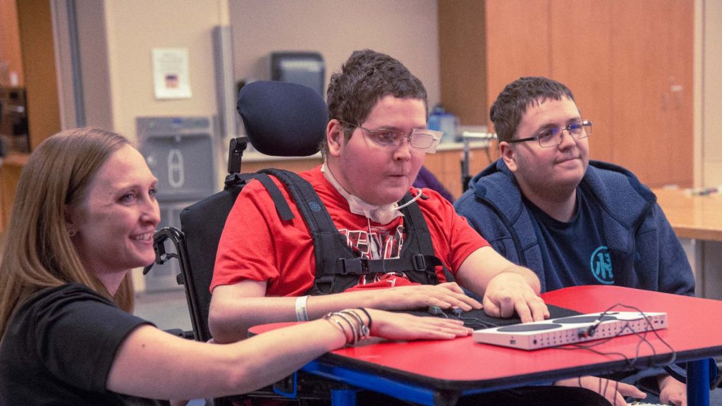 young man in wheelchair uses Adaptive Controller