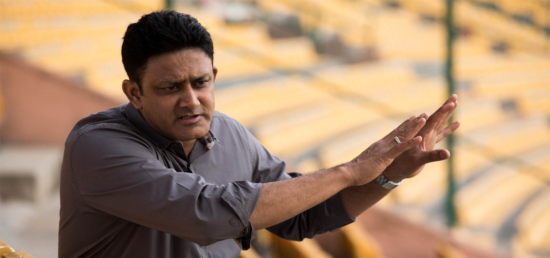 Anil Kumble explains concept to someone with hands raised