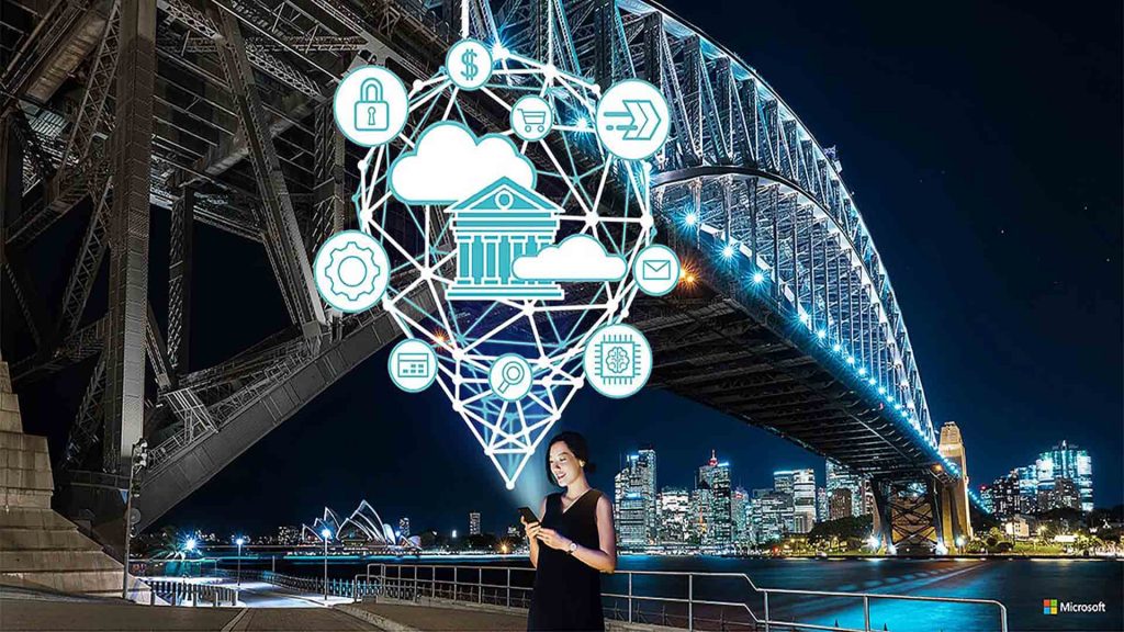 woman smiles at her phone in front of the sydney harbour bridge