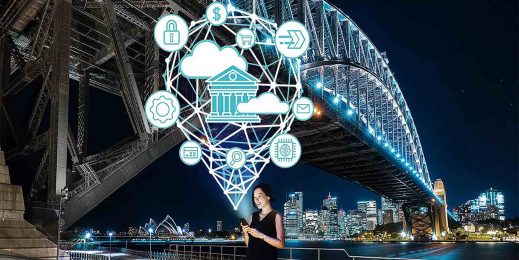 woman smiles at her phone in front of the sydney harbour bridge