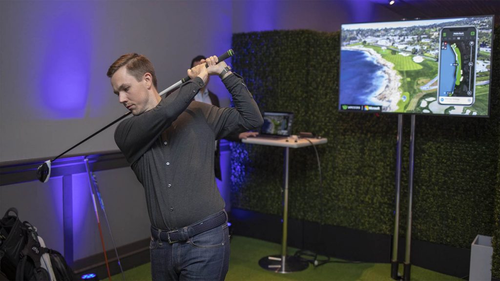 Coleman McDowell, marketing manager for Arccos Golf, demonstrates the Arccos Caddie at a Conversations in AI event in San Francisco. Photo by John Brecher for Microsoft.