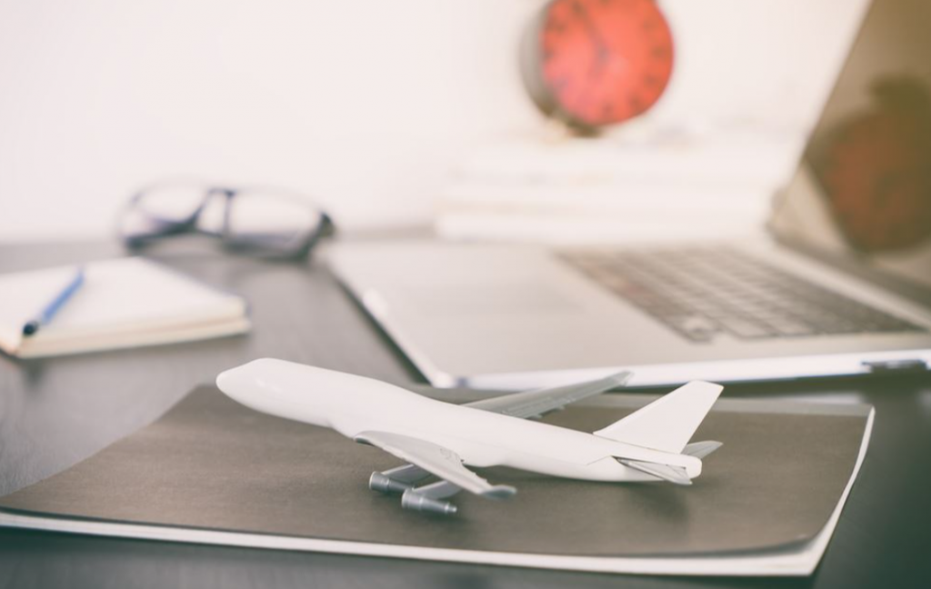 Toy aeroplane next to laptop