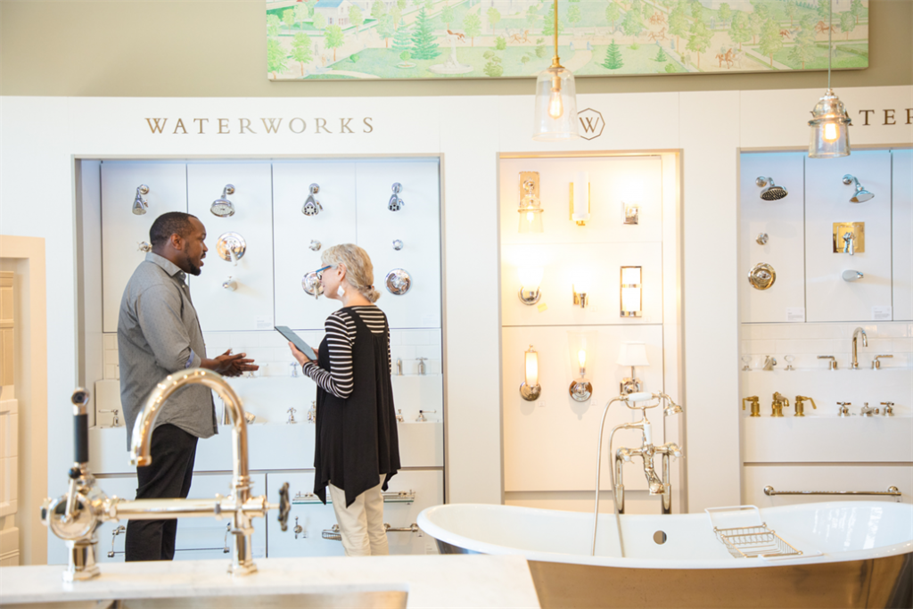 Sales person talking to customer in bathroom store