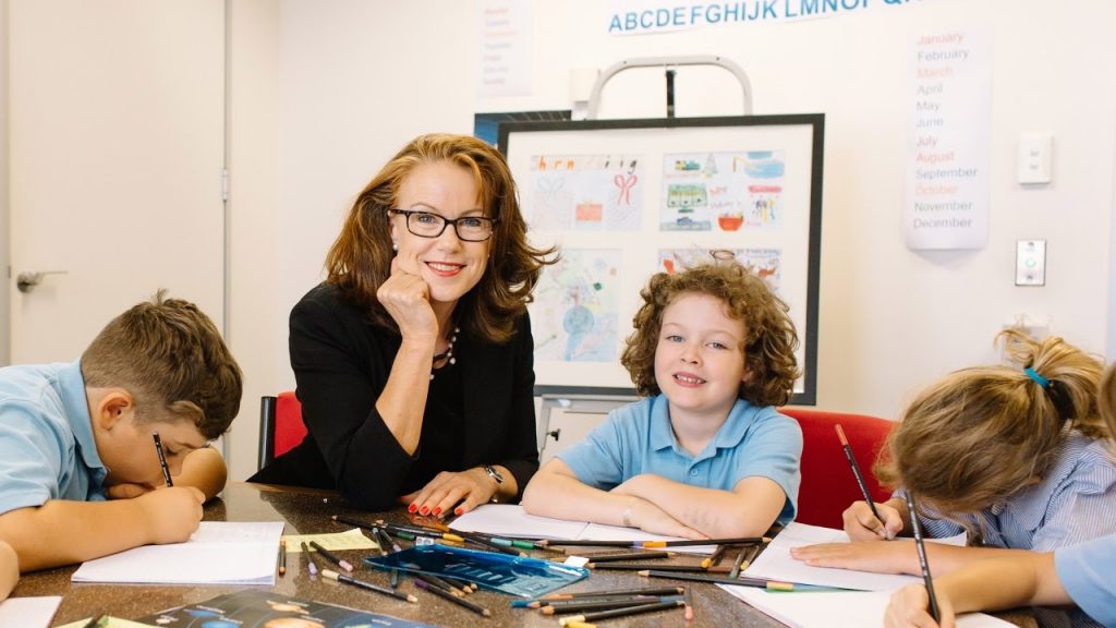 Charity worker with young students