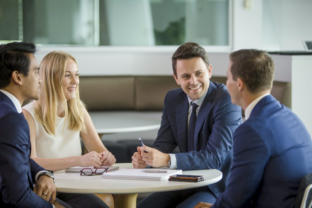 Group of employees gathered at a round table